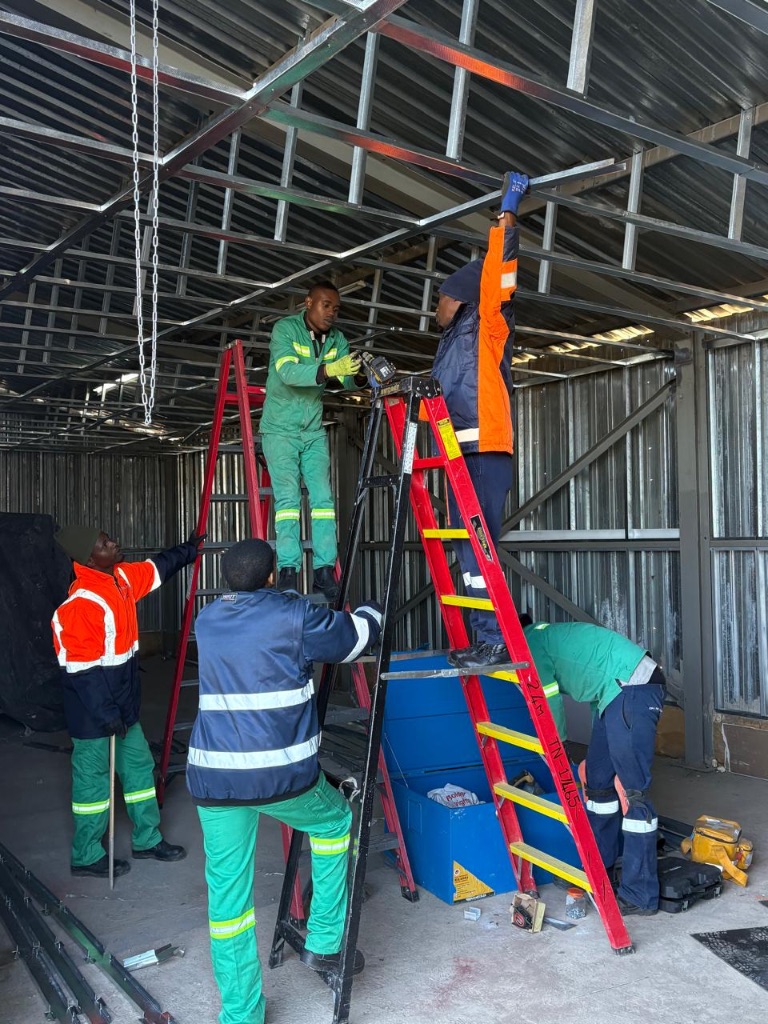 Team ladder work in warehouse